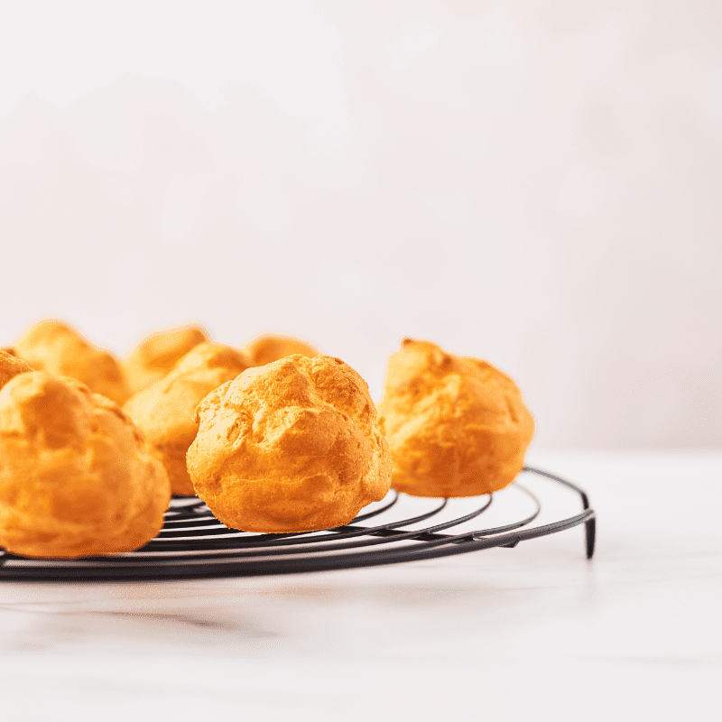 Foto de vários choux cream sobre uma mesa.